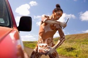 Native Rapa Nui Man painting his body, Easter Island, Chile
